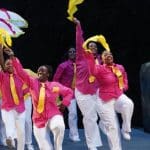 Latanya d. Tigner leads members of Dimensions Dance Theater in a second line parade. Photo by Jay Yamada