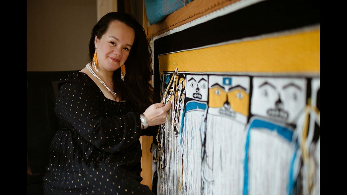 Tlingit artist Lily Hope with a Chilkat weaving