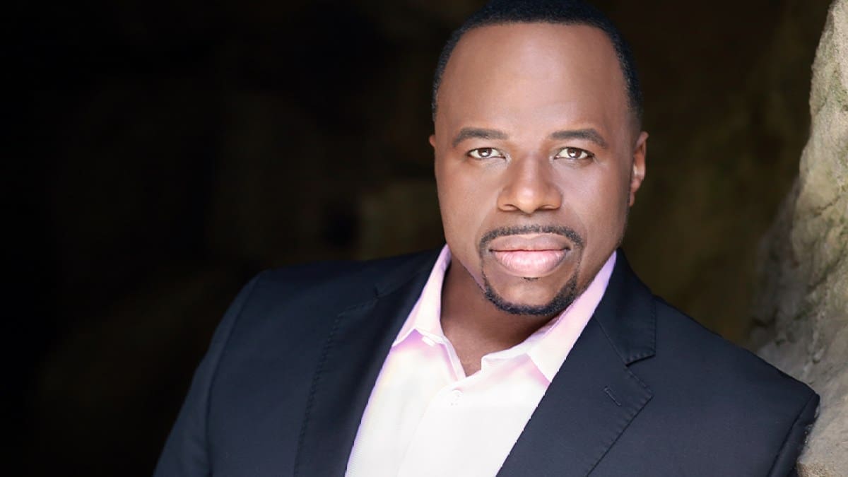 Baritone Lester Lynch, a black man wearing a dark suit and a light pink shirt looking into the camera.