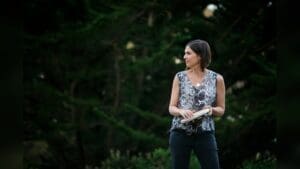 Ami Molinelli holding a percussion instrument outdoors