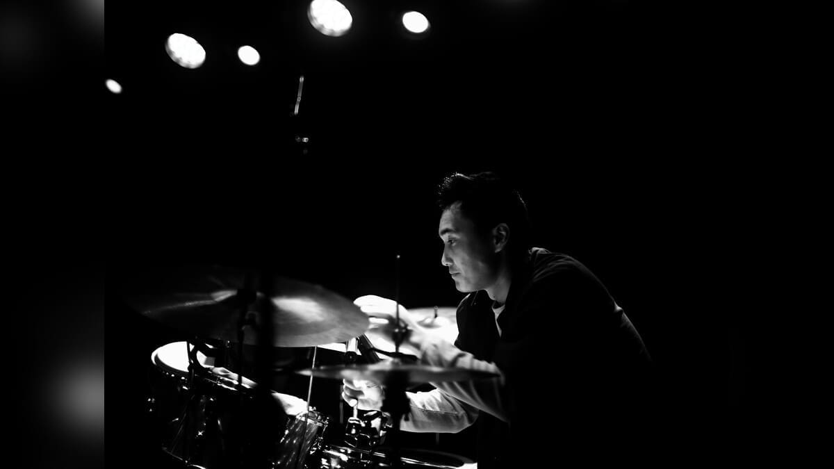 Shane Sato playing drums