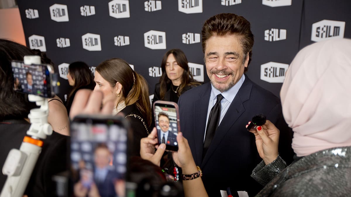 Benicio del Toro smiles while speaking with reporters at an SFFILM Awards Night red carpet.