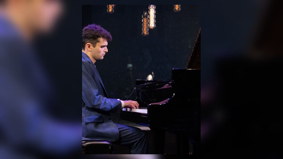 Brahm Sasner seated at a piano