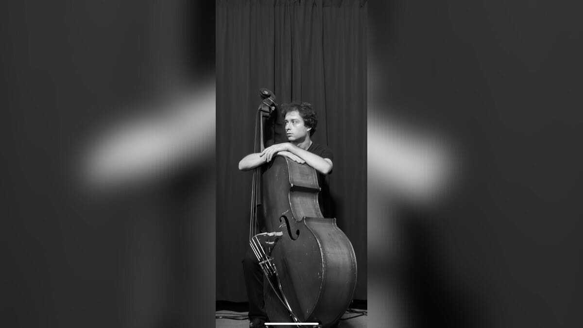 Isaac Coyle standing with an upright bass