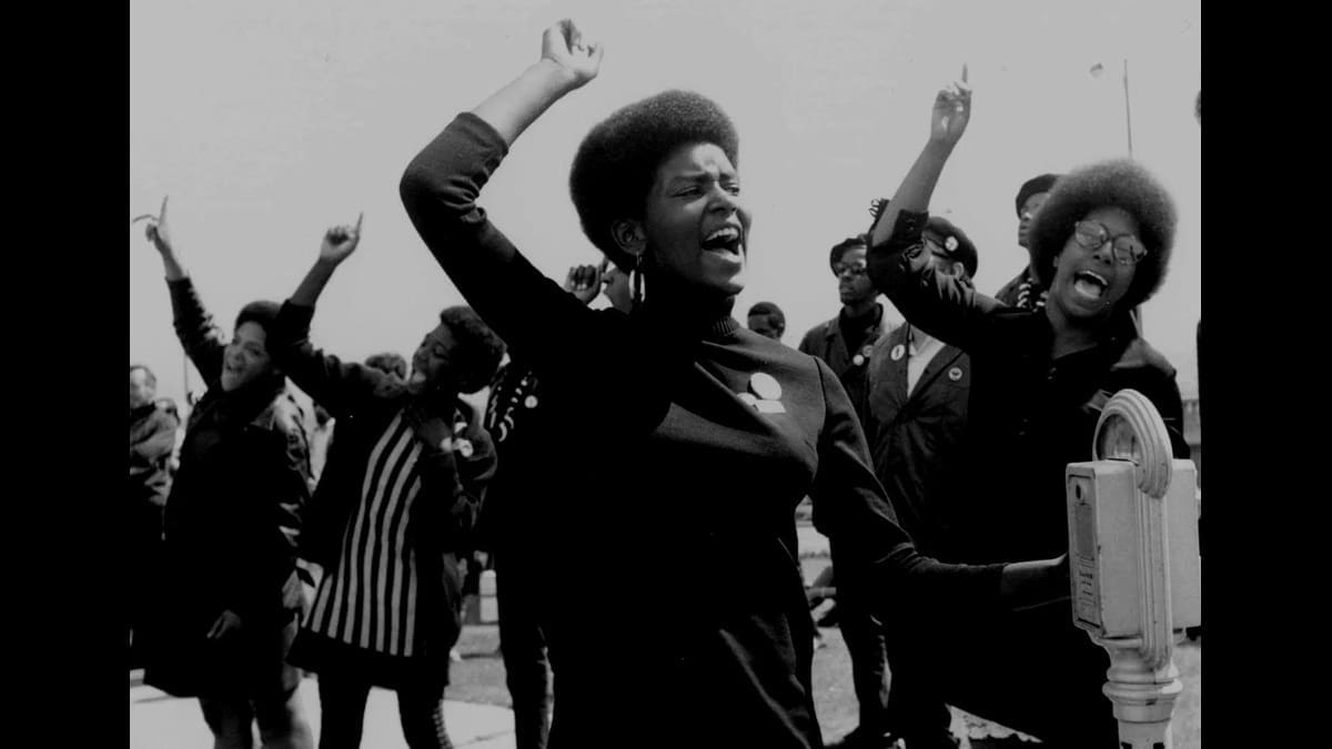 Historical photograph of people gathered at a Black Panther Party demonstration.