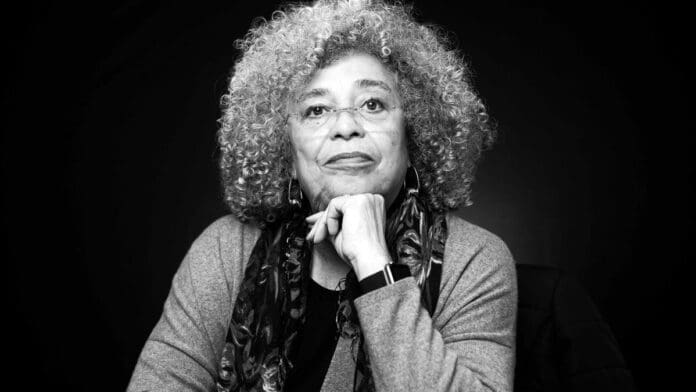 Angela Davis resting her chin on her hand at Oregon State University in 2019.