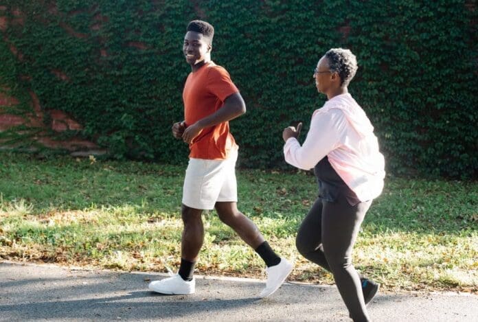 Two adults jogging together outdoors.